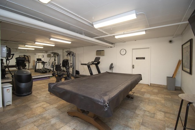 game room with stone tile floors, pool table, and a wall mounted air conditioner