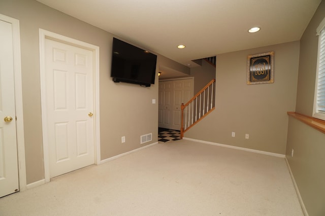 carpeted empty room featuring stairs, recessed lighting, and baseboards