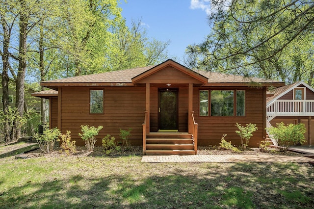 25985 Smithtown Rd, Shorewood, MN 55331 - view of front of house with a front yard and a shingled roof