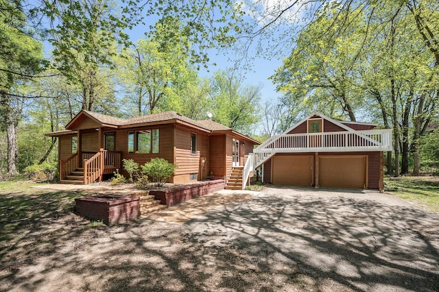 25985 Smithtown Rd, Shorewood, MN 55331 - view of front of home with stairs, driveway, and roof with shingles