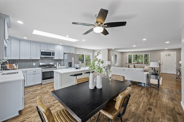 25985 Smithtown Rd, Shorewood, MN 55331 - kitchen with stainless steel appliances, light countertops, a ceiling fan, plenty of natural light, and recessed lighting