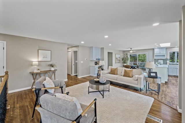 25985 Smithtown Rd, Shorewood, MN 55331 - living area with dark wood-type flooring, recessed lighting, a ceiling fan, and baseboards