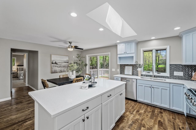 25985 Smithtown Rd, Shorewood, MN 55331 - kitchen with dishwasher, a sink, light countertops, tasteful backsplash, and dark wood finished floors