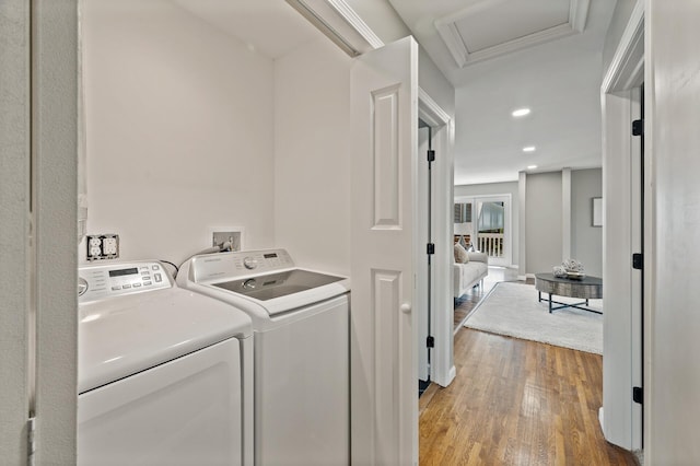 25985 Smithtown Rd, Shorewood, MN 55331 - laundry room featuring washer and clothes dryer, light wood-style flooring, attic access, and recessed lighting