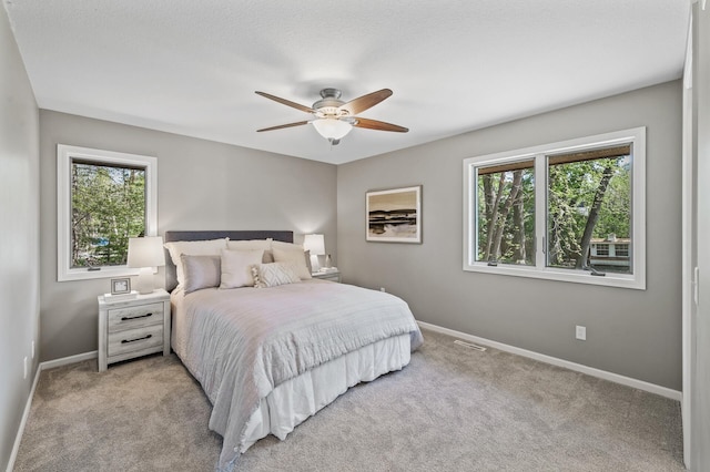 25985 Smithtown Rd, Shorewood, MN 55331 - bedroom featuring multiple windows, baseboards, carpet flooring, and ceiling fan