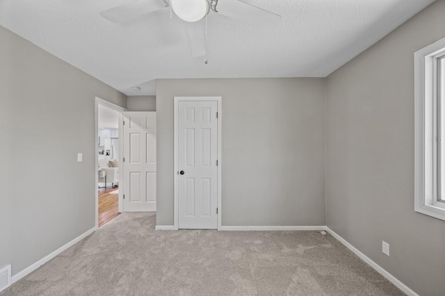 25985 Smithtown Rd, Shorewood, MN 55331 - unfurnished bedroom featuring carpet floors, baseboards, a textured ceiling, and a ceiling fan