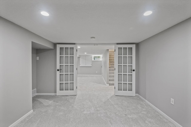 25985 Smithtown Rd, Shorewood, MN 55331 - empty room featuring french doors, carpet floors, recessed lighting, baseboards, and stairs