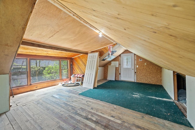 25985 Smithtown Rd, Shorewood, MN 55331 - additional living space with plenty of natural light, lofted ceiling, hardwood / wood-style floors, and wood walls