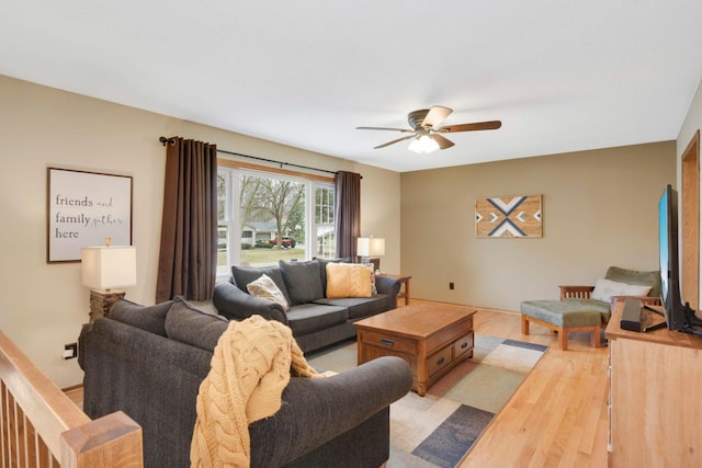 living room featuring light wood-style floors and a ceiling fan