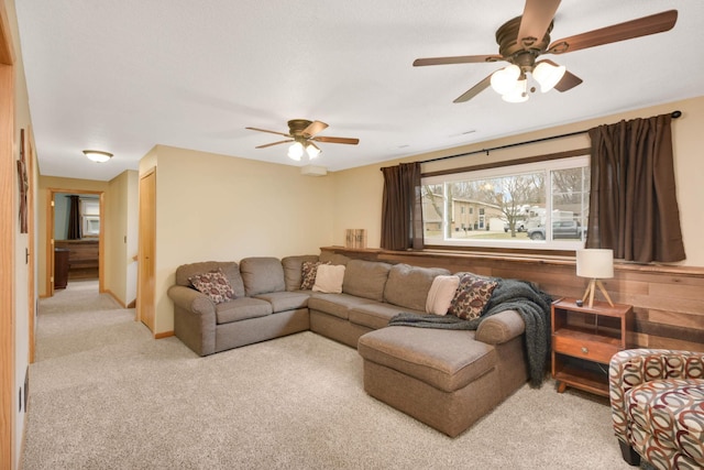 carpeted living room with a ceiling fan