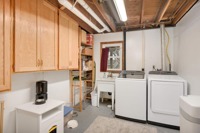washroom featuring separate washer and dryer and cabinet space