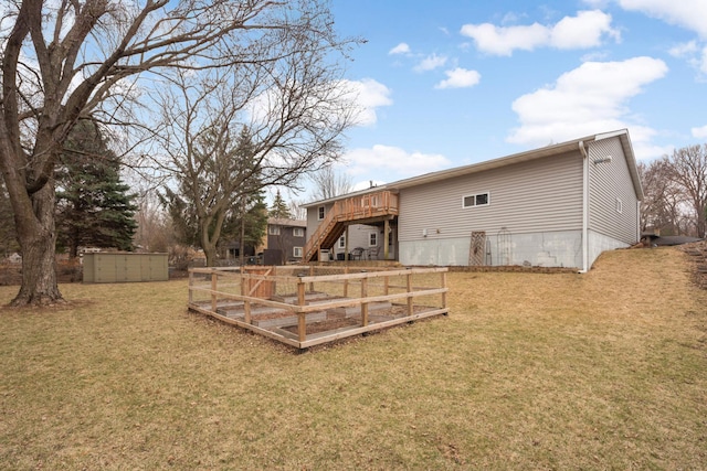 back of house with a lawn, stairs, and a deck