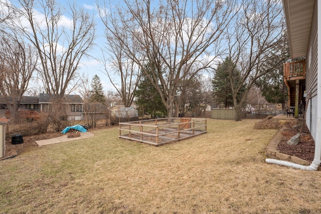 view of yard featuring fence and a garden