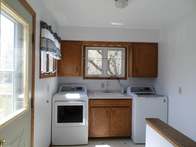 202 Buse Ave NE, Red Lake Falls, MN 56750 - clothes washing area featuring separate washer and dryer, a healthy amount of sunlight, cabinet space, and a sink