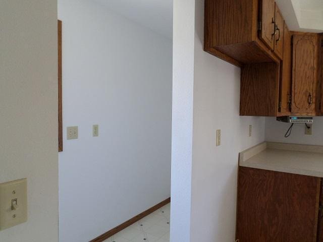 202 Buse Ave NE, Red Lake Falls, MN 56750 - kitchen featuring light countertops, brown cabinets, and baseboards