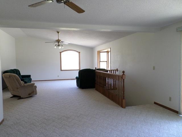 202 Buse Ave NE, Red Lake Falls, MN 56750 - sitting room with a textured ceiling, carpet floors, a ceiling fan, and baseboards