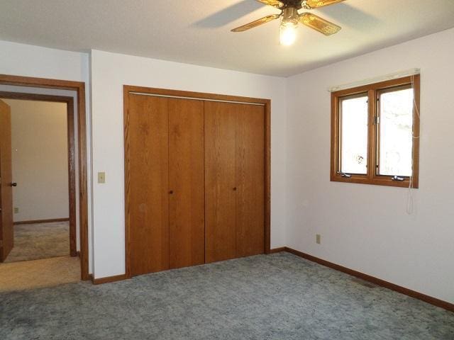 202 Buse Ave NE, Red Lake Falls, MN 56750 - unfurnished bedroom with baseboards, a closet, ceiling fan, and carpet