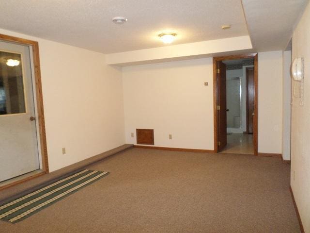 202 Buse Ave NE, Red Lake Falls, MN 56750 - empty room with carpet flooring, visible vents, and baseboards