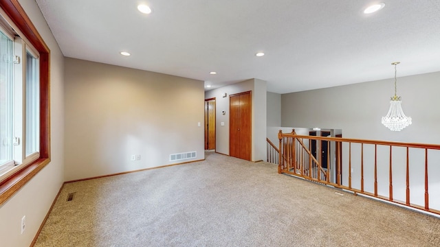 unfurnished room featuring a chandelier, carpet, visible vents, and recessed lighting