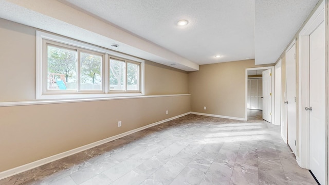 unfurnished bedroom featuring baseboards, recessed lighting, and a textured ceiling