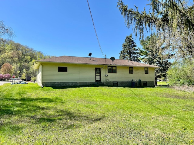 rear view of property with a yard and central air condition unit
