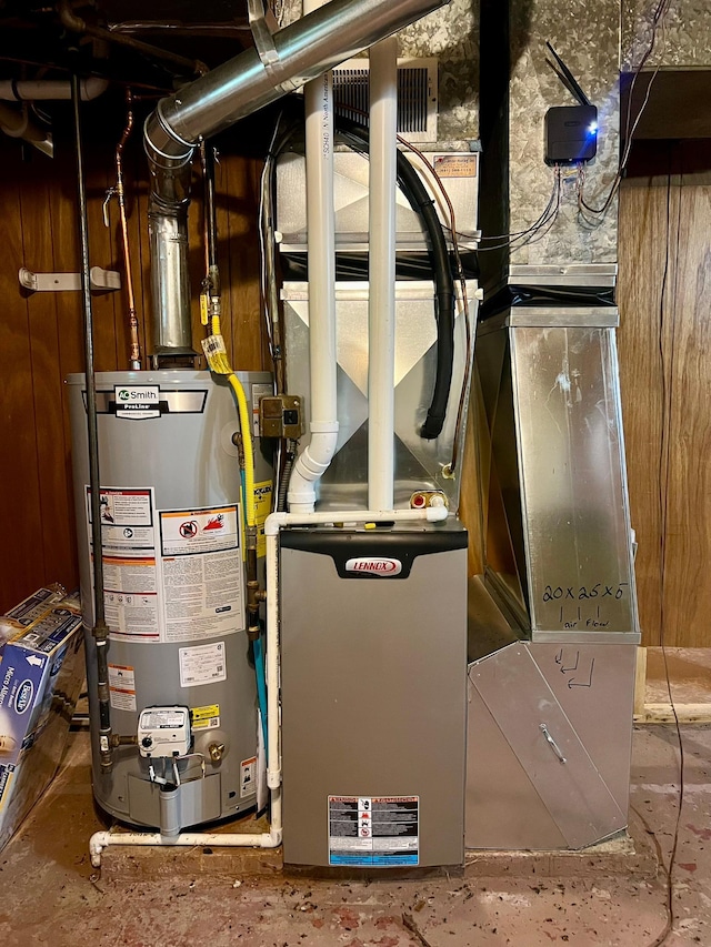 utility room featuring water heater