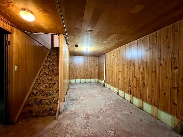 finished below grade area with stairway and wooden walls