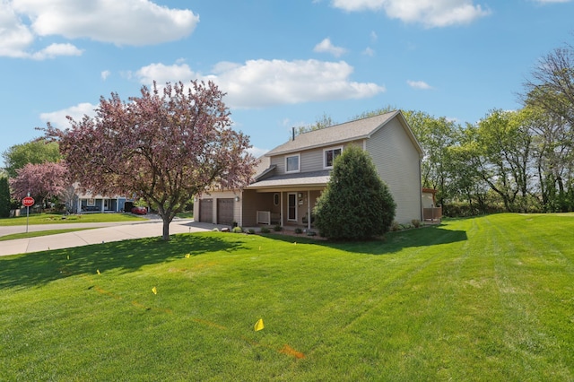 view of front of property featuring driveway, a garage, and a front lawn
