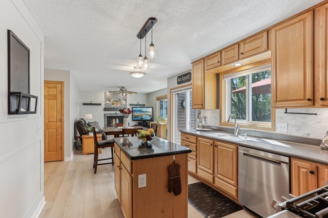 kitchen with dishwasher, a sink, backsplash, a ceiling fan, and dark countertops