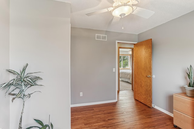 bedroom with wood finished floors, baseboards, and a ceiling fan