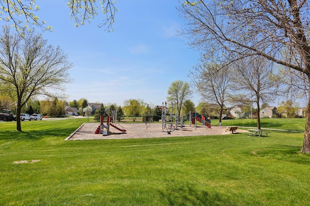 community jungle gym featuring a yard