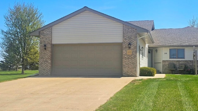 view of front facade featuring a garage, driveway, brick siding, and a front yard