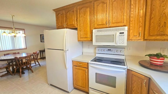 kitchen with white appliances, brown cabinets, light countertops, a chandelier, and decorative light fixtures