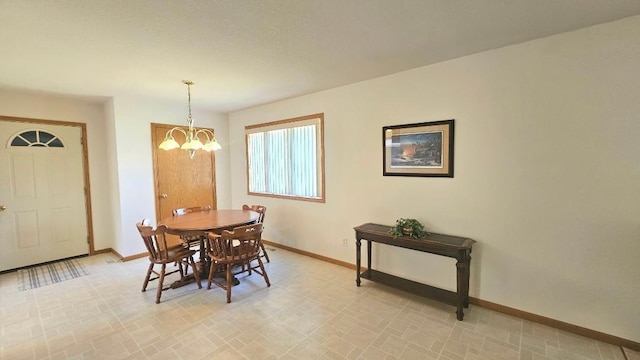 dining area with a chandelier and baseboards