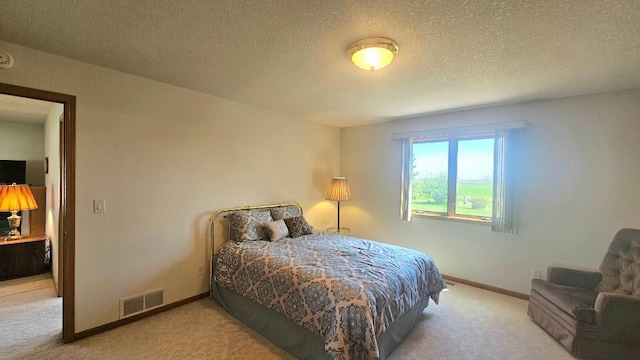 carpeted bedroom featuring baseboards and a textured ceiling