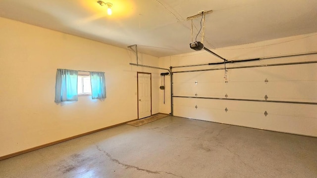 garage with a garage door opener and baseboards