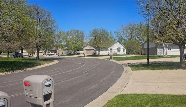 view of asphalt road featuring a residential view