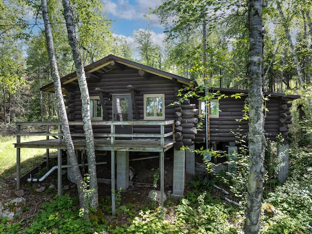 back of house featuring log siding