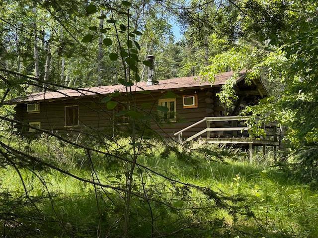 view of side of home with log exterior