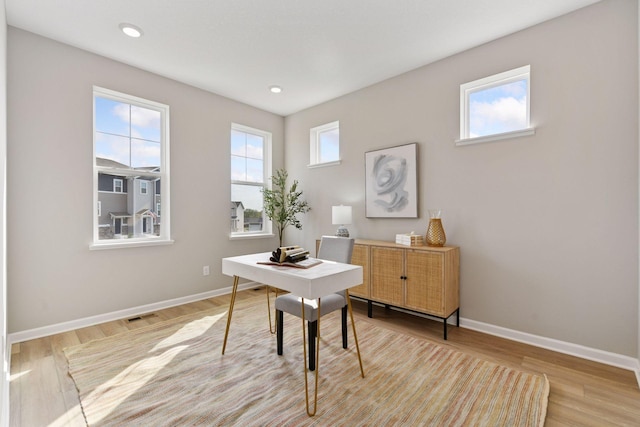 office area with baseboards, light wood-type flooring, and recessed lighting