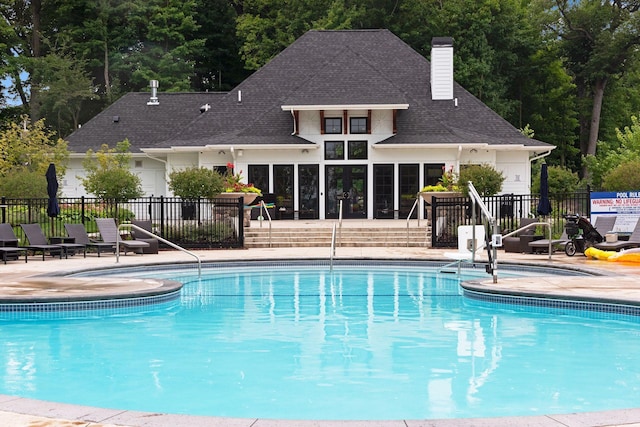 community pool featuring fence and a patio area