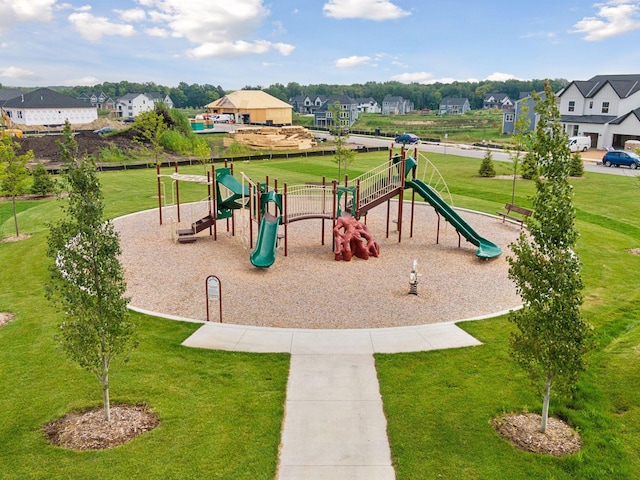 community jungle gym with a yard and a residential view