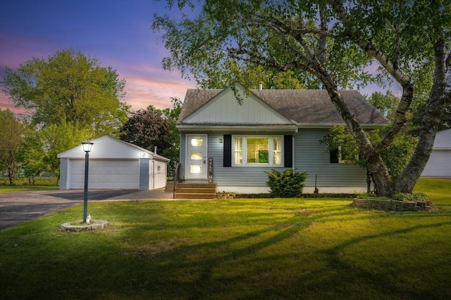 7719 60th Ave N, New Hope, MN 55428 - view of front of property with an outbuilding, a garage, a shingled roof, a front lawn, and entry steps