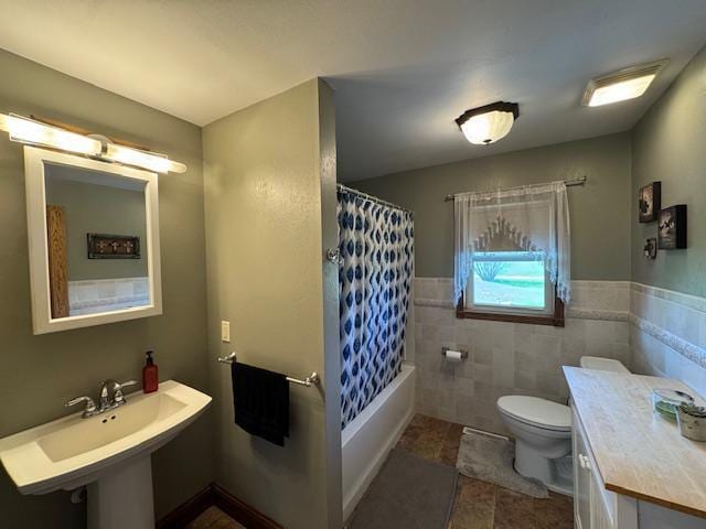 full bath with toilet, shower / bathtub combination with curtain, tile walls, tile patterned flooring, and a sink