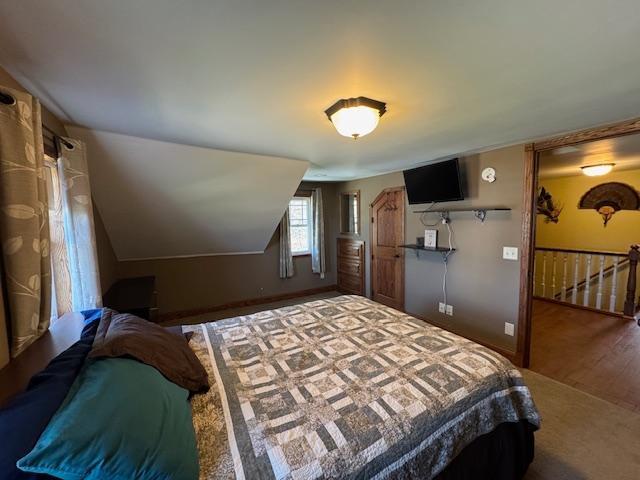 bedroom featuring wood finished floors and baseboards