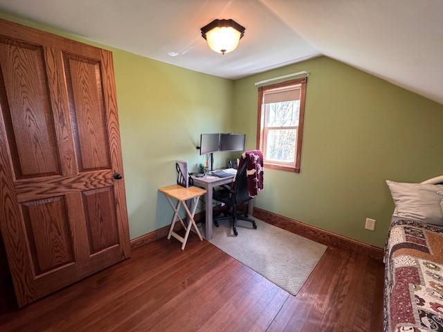 home office with wood finished floors, lofted ceiling, and baseboards