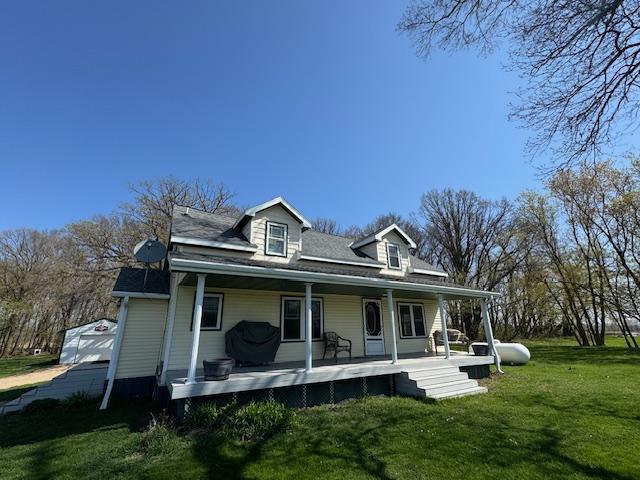 back of house featuring a yard and a porch