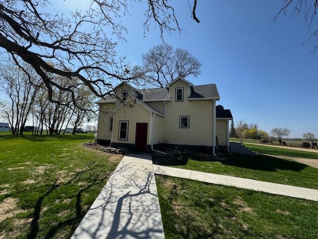 bungalow-style home with a front yard