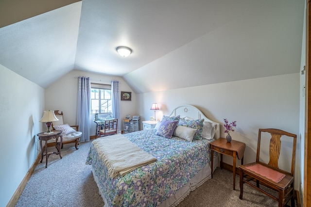 carpeted bedroom featuring vaulted ceiling and baseboards