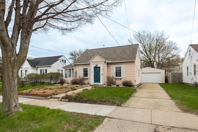 bungalow featuring a detached garage, an outdoor structure, and roof with shingles